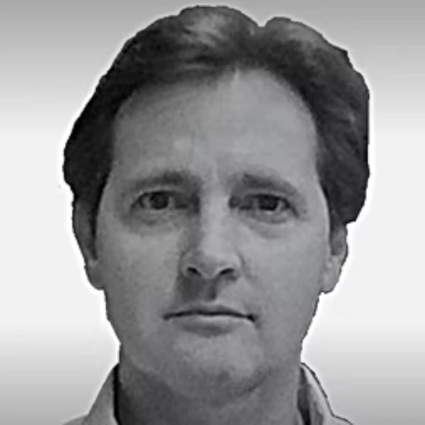 Black and white portrait of John Archer with short dark hair, looking directly at the camera with a neutral expression. The background is plain and light-colored.